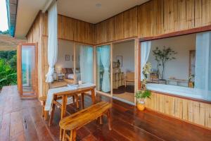 a wooden room with a table and a bench at Wintery House in Ban Thung Phan Ha
