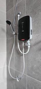 a hair dryer on a wall in a bathroom at Suria Aman Homestay Semi-D 5 Rooms 5 Bathrooms in Taiping +43 photos