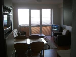 a living room with a couch and chairs and a television at Horec Apartment 2 in Donovaly