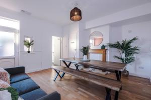 a living room with a table and a couch at BIG House for Business Stays in Barnsley with 6-bedrooms & 8 Beds by PureStay in Barnsley