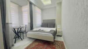 a small bedroom with a bed and a table at La Mer Old City Hotel in Istanbul