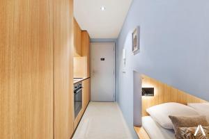 a small room with a bed and a kitchen at Modern and Cozy Studio Retreat near the City in Luxembourg