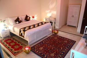 a bedroom with a large bed and a rug at Hotel Dior Near Jal Mahal, Jaipur in Jaipur