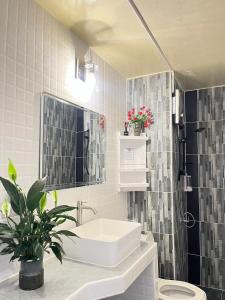 a white bathroom with a sink and a toilet at T12 Popular Condo By hunnity 2 in Ban Bang Phang