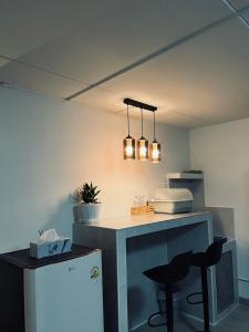 a kitchen with a counter and a refrigerator at T12 Popular Condo By hunnity 2 in Ban Bang Phang