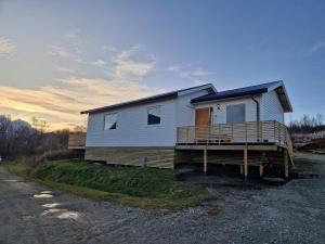 a house sitting on the side of a road at Arctic Cabin - Mellomgaard on southern Kvaløya #sauna & bbq hut on site! in Tromsø