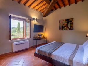 a bedroom with a large bed and a window at Villa Poggio alla Staffa in Poderi Foci +86 photos