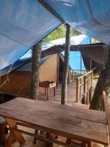a tent with a wooden table in front of it at Rustic Campsite Kalutara South in Kalutara