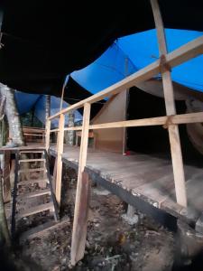 a tent with a wooden floor and a ladder at Rustic Campsite Kalutara South in Kalutara