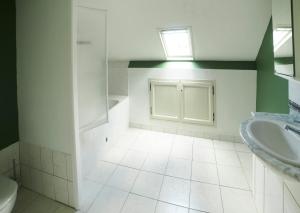 a bathroom with a sink and a toilet and a window at Ferme de Franqueville in Sainte-Marie-du-Mont +39 photos