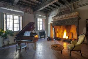 a living room with a piano and a fireplace at Villa Berla in Azzate +52 photos