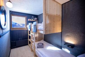 a bedroom with two bunk beds in a room at Hunter Lodge by Gryon Confort in Gryon