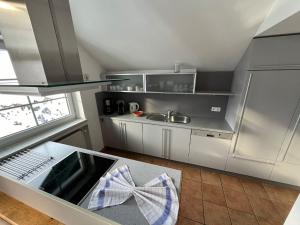 a kitchen with stainless steel appliances with a bow on the counter at Fewo-Obertauern Maisonette in Obertauern