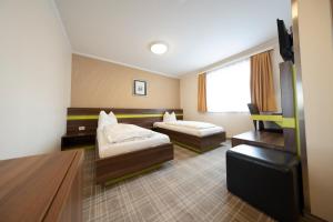 Posteľ alebo postele v izbe v ubytovaní Primus Hotel & Apartments
