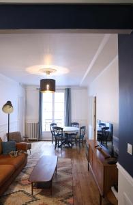 a living room with a couch and a table at Le Square in Le Havre