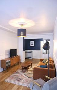 a living room with a couch and a table at Le Square in Le Havre