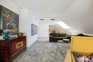 a living room with a yellow chair and a couch at BlueSunset Penthouse in Manilva