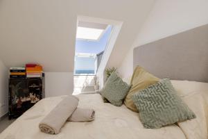 a bedroom with a bed with pillows and a window at BlueSunset Penthouse in Manilva +62 photos
