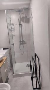 a shower with a glass door in a bathroom at apartament in Tomaszów Mazowiecki