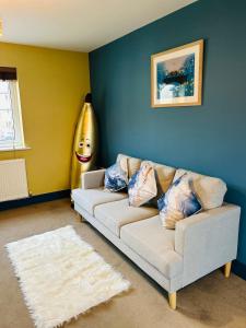 a living room with a white couch and a giant banana at Wonderful two bedroom house in Bicester in Chesterton