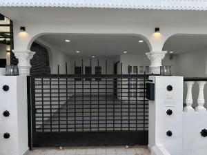a room with a gate with a staircase in it at Newstar Jacuzzi Homestay Near Jonker Kota Laksamana Melaka in Melaka