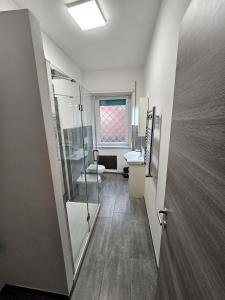 a bathroom with a walk in shower and a sink at Ciampino Aeroporto - Casa moderna in Ciampino +17 photos