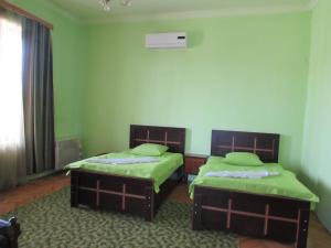 Postel nebo postele na pokoji v ubytování Guest House Nona