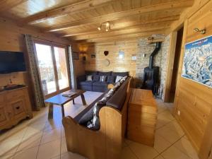 a large living room with a couch and a fireplace at Chalet Le Castor : dans le centre de Chatel in Châtel