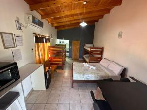 a kitchen and living room with a couch and a table at Jenny Two in General Pico