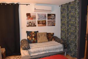 a room with a couch and pictures on the wall at La Conté in La Coste +2 photos