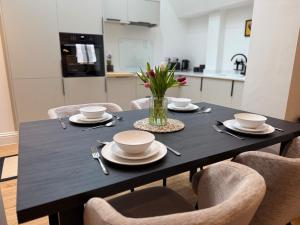 a dining room table with chairs and a black table at Spacious, Worcester city centre 2 bedroom apartment in Worcester +32 photos