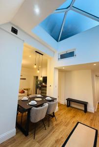 a living room with a dining table and a skylight at Spacious, Worcester city centre 2 bedroom apartment in Worcester