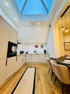 a kitchen with a dining table and a skylight at Spacious, Worcester city centre 2 bedroom apartment in Worcester