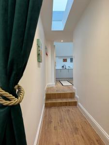 a hallway with a curtain and stairs in a house at Spacious, Worcester city centre 2 bedroom apartment in Worcester