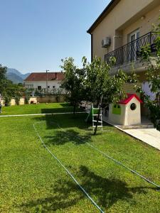 a yard with a basketball hoop in the grass at Private luxurious house with pool for 15 people in Tivat