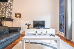 a living room with a couch and a coffee table at Bar à Bulles - Ancien Comptoir Transformé in Reims