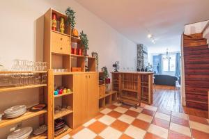 a kitchen with wooden shelves and a table in a room at Bar à Bulles - Ancien Comptoir Transformé in Reims