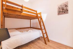 a bedroom with a bunk bed with a ladder at Bar à Bulles - Ancien Comptoir Transformé in Reims