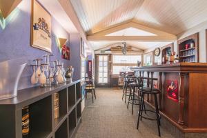 a bar in a restaurant with a counter and stools at Bar à Bulles - Ancien Comptoir Transformé in Reims