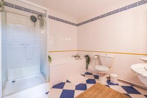 a bathroom with a shower and a toilet and a sink at Bar à Bulles - Ancien Comptoir Transformé in Reims +27 photos