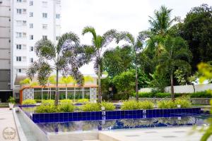 a courtyard with palm trees and a building at Cozy Home in Cebu City