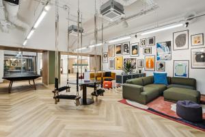 a living room with a couch and a table at Ultra-Luxury Modern Apartment with Gym, Cinema, Game Room and Parking in Kew Bridge