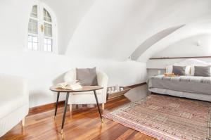 a bedroom with a bed and a table and a chair at Villa Erofili in Fira