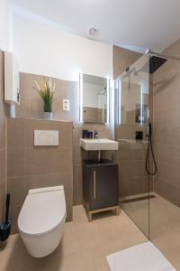 a bathroom with a toilet and a sink at Neues und zentrales Apartment im Ruhrgebiets-Style von STAY YOUR WAY in Essen +38 photos