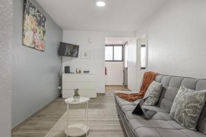 a living room with a couch and a table at Seaside Charm I in Câmara de Lobos