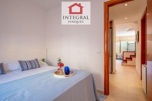 a bedroom with a bed with a table in it at Ca la Blava Palamós in Palamós
