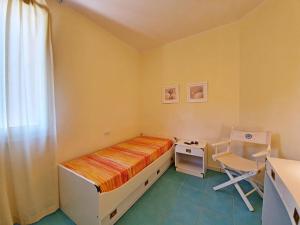 a small bedroom with a bed and a desk at La Pergola al Cavo 107 in Cavo +28 photos