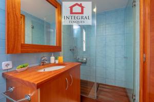 a bathroom with a sink and a shower with a mirror at Ca la Blava Palamós in Palamós +21 photos