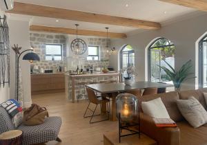 a kitchen and living room with a couch and a table at 2 Riverside Oaks in Franschhoek