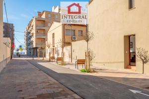 an empty street in a city with a building at Ca la Blava Palamós in Palamós